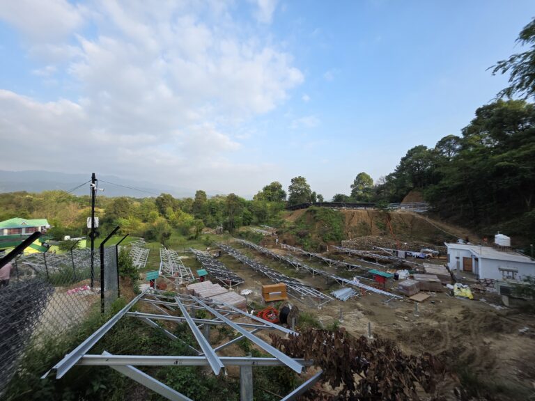 Steel mounting structures arranged across a hillside solar site.