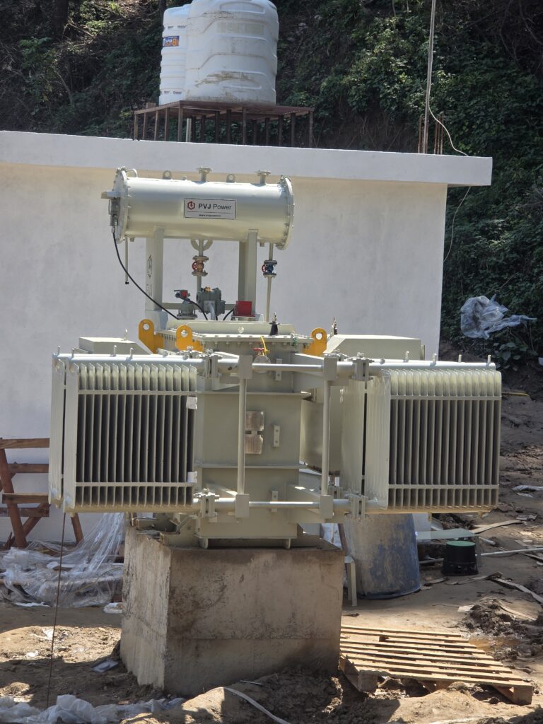 Electrical transformer equipment installed on a concrete foundation.