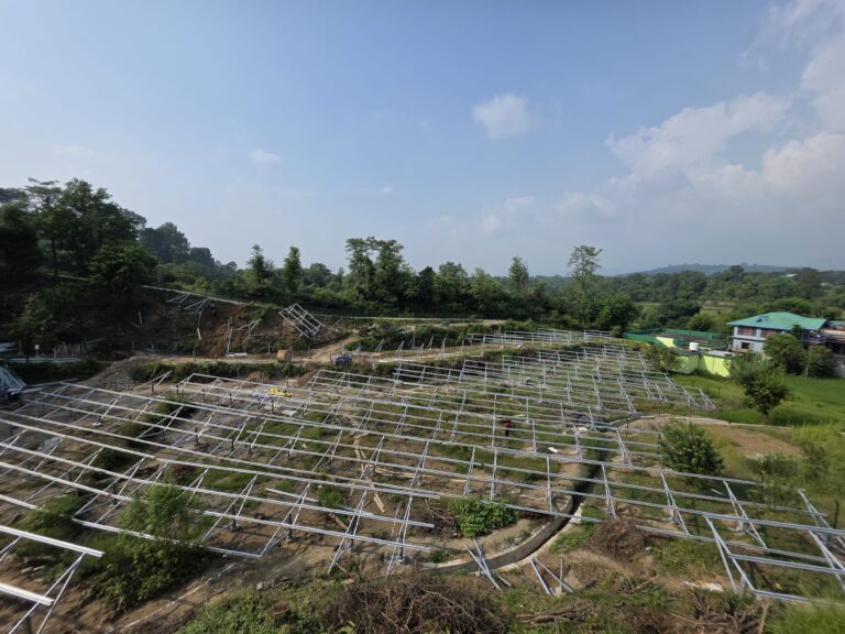 Rows of steel solar mounting structures across the site.